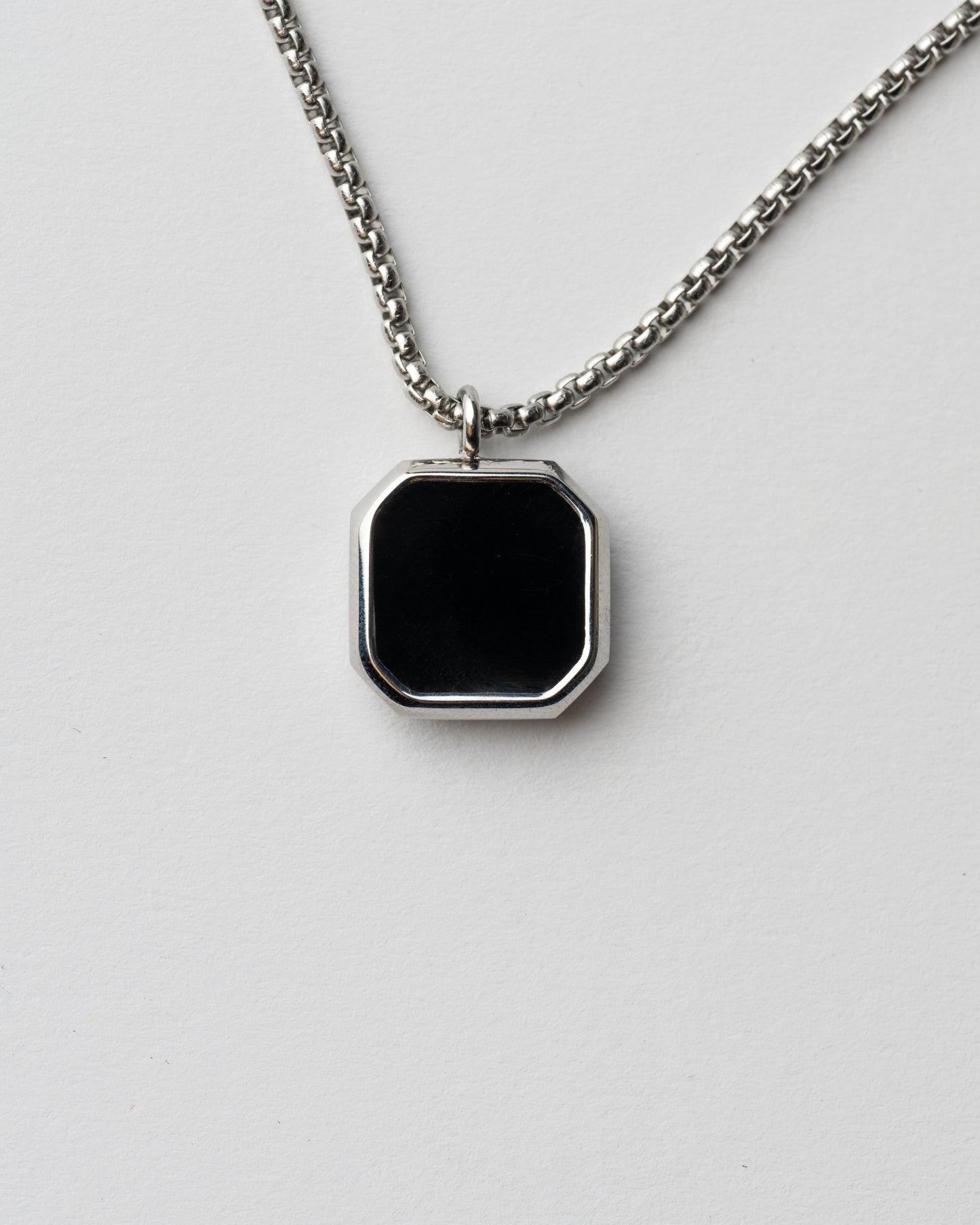 Collar inteligente plateado con chip NFC para hombre en fondo blanco. 